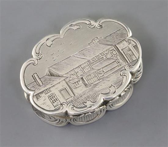 A Victorian silver cusped oval vinaigrette by Nathaniel Mills, the lid engraved with houses,